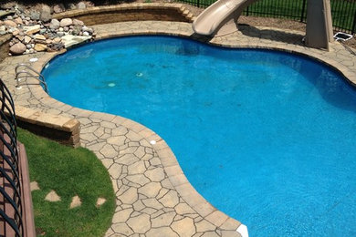 Example of a large classic backyard stone and custom-shaped water slide design in Chicago
