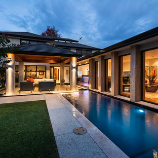 Photo of a small contemporary side yard rectangular lap pool in Perth with tile.