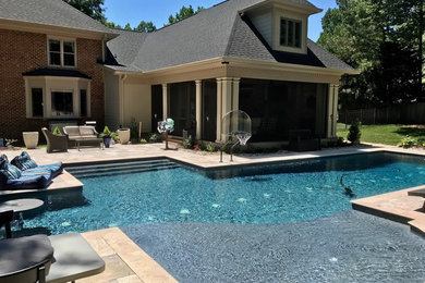 Pool - large transitional backyard stone and custom-shaped lap pool idea in Charlotte