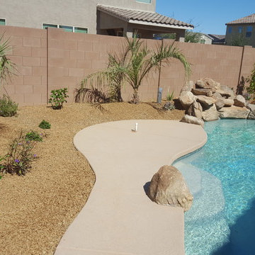 FREE FORM POOL WITH ROCK WATERFALL AND LANDSCAPE