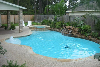 Inspiration for a transitional backyard custom-shaped pool remodel in Houston