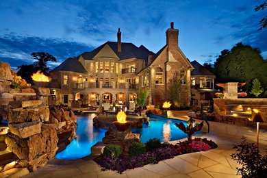 Pool fountain - large traditional backyard stone and custom-shaped natural pool fountain idea in Chicago