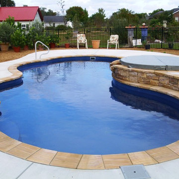 Freeform Pools Deep Blue Fiberglass with Tennessee Crab Orchard stone coping and