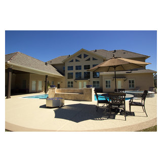 Freeform Swimming Pool With Travertine And Feature Wall Mediterranean