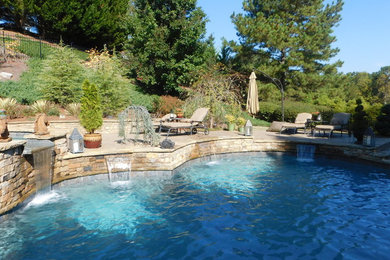 Pool fountain - large traditional backyard stone and custom-shaped natural pool fountain idea in Atlanta