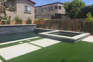 Example of a mid-sized trendy backyard concrete and rectangular aboveground hot tub design in Los Angeles