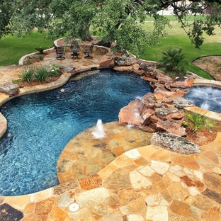 Inspiration for a mid-sized rustic backyard stone and custom-shaped natural pool fountain remodel in Austin