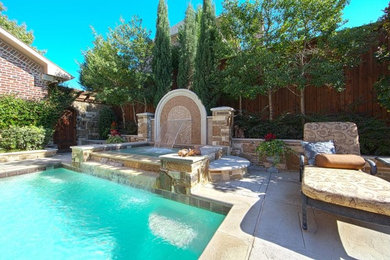 Large elegant backyard rectangular and stamped concrete pool fountain photo in Dallas