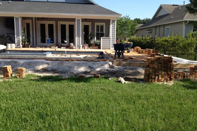 Inspiration for a large rustic backyard brick and rectangular pool remodel in Tampa