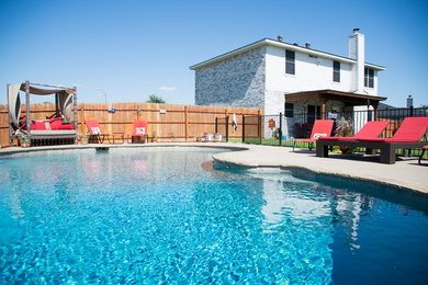 Pool - large transitional backyard concrete and custom-shaped pool idea in Dallas