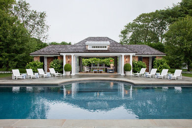 Inspiration for a large contemporary side yard stone and custom-shaped pool fountain remodel in New York