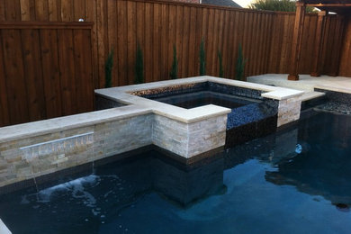 Mid-sized minimalist backyard stone and rectangular natural hot tub photo in Dallas