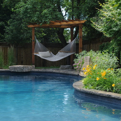 Inspiration for a mid-sized timeless backyard stone pool fountain remodel in Toronto