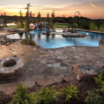 Glass Tiled Pool With A Rustic Island Oasis in Oklahoma