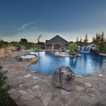 Glass Tiled Pool With A Rustic Island Oasis in Oklahoma