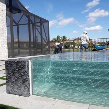 glass wall pool with sunken living room