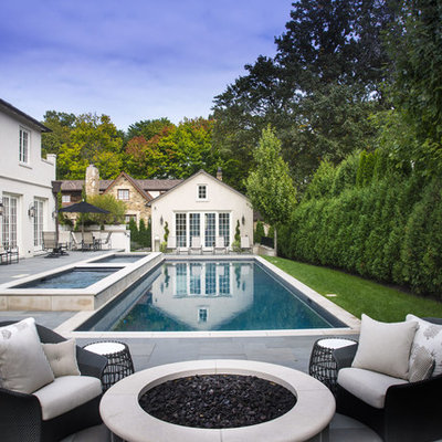 Example of a mid-sized classic backyard concrete paver and rectangular pool house design in Chicago