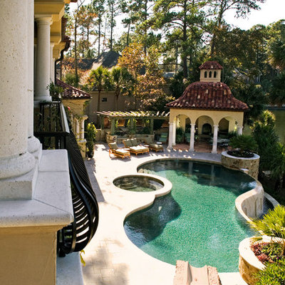 Large tuscan backyard concrete paver and custom-shaped lap hot tub photo in Atlanta
