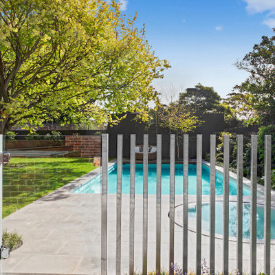 Example of a mid-sized minimalist backyard stone and custom-shaped pool landscaping design in Melbourne