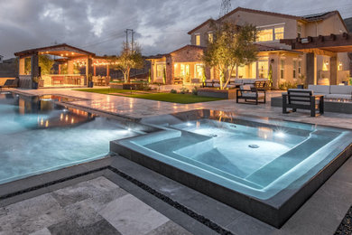 Hot tub - large contemporary backyard stone and custom-shaped infinity hot tub idea in San Diego