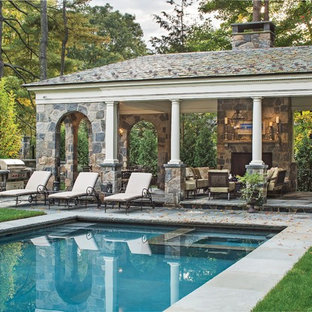 This is an example of an expansive traditional rectangular pool in New York with a pool house.