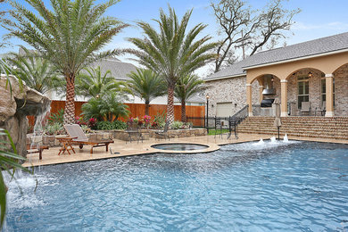 Pool fountain - mid-sized traditional backyard stamped concrete and rectangular lap pool fountain idea in New Orleans