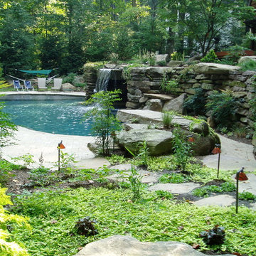 Grotto with pool house and running stream