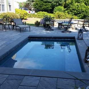 Inspiration for a modern backyard stone and l-shaped pool remodel in New York