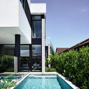 Design ideas for a small contemporary backyard rectangular lap pool in Melbourne with concrete slab.