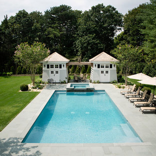 Large elegant backyard stone and rectangular natural hot tub photo in New York