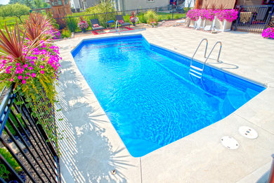 Design ideas for a medium sized modern back l-shaped swimming pool in Other with concrete slabs.