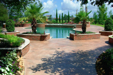 Hot tub - large traditional backyard concrete and custom-shaped hot tub idea in New Orleans