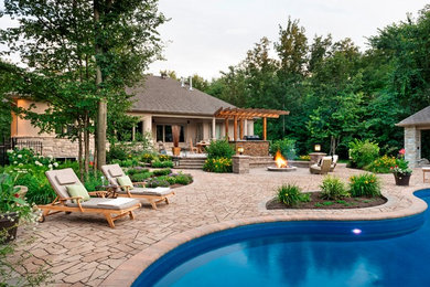 Example of a large mountain style backyard concrete paver and custom-shaped pool design in New York