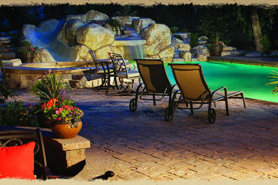 Example of a mid-sized mountain style backyard concrete paver and rectangular lap hot tub design in Other