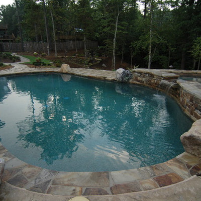 Hot tub - mid-sized rustic backyard stone and kidney-shaped hot tub idea in Atlanta