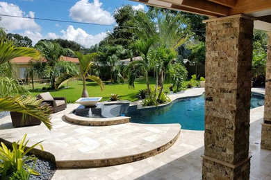 Example of a large trendy backyard custom-shaped lap hot tub design in Tampa
