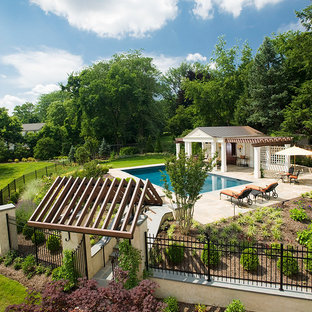 Mid-sized victorian backyard rectangular pool in Philadelphia with a pool house and natural stone pavers.