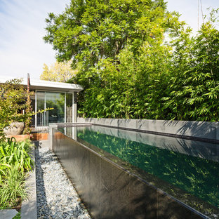 Photo of a mid-sized asian backyard rectangular infinity pool in Melbourne with tile.