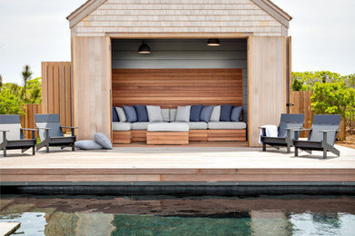 Trendy pool house photo in Boston with decking