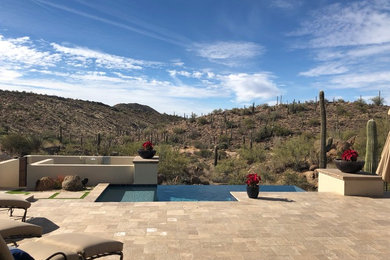 Pool - small contemporary backyard stone and custom-shaped infinity pool idea in Phoenix