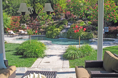 Inspiration for a large timeless backyard stone and custom-shaped natural pool fountain remodel in San Francisco