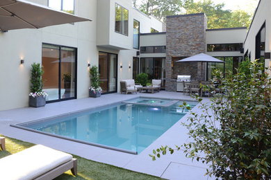 Example of a large minimalist backyard tile and rectangular natural hot tub design in Atlanta