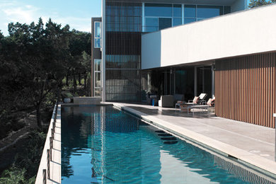 Pool - large modern backyard concrete and rectangular lap pool idea in Austin