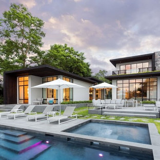 Photo of an expansive contemporary backyard rectangular lap pool in New York with a hot tub and concrete pavers.