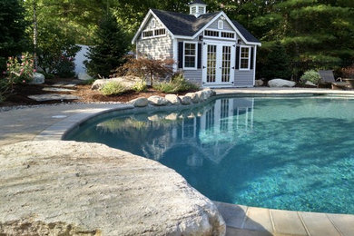 Inspiration for a large timeless backyard concrete paver and round pool house remodel in Boston