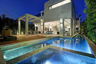 Pool - large modern backyard custom-shaped aboveground pool idea in Los Angeles