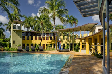Island style courtyard rectangular pool photo in Miami