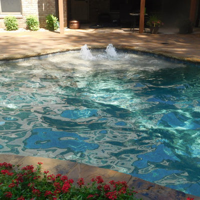 Inspiration for a mid-sized rustic backyard brick and custom-shaped natural hot tub remodel in Atlanta