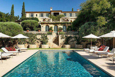 Pool house - huge mediterranean backyard concrete paver and rectangular lap pool house idea in Santa Barbara