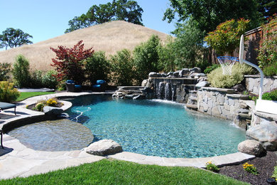 Huge mountain style backyard stone and custom-shaped natural pool fountain photo in San Francisco